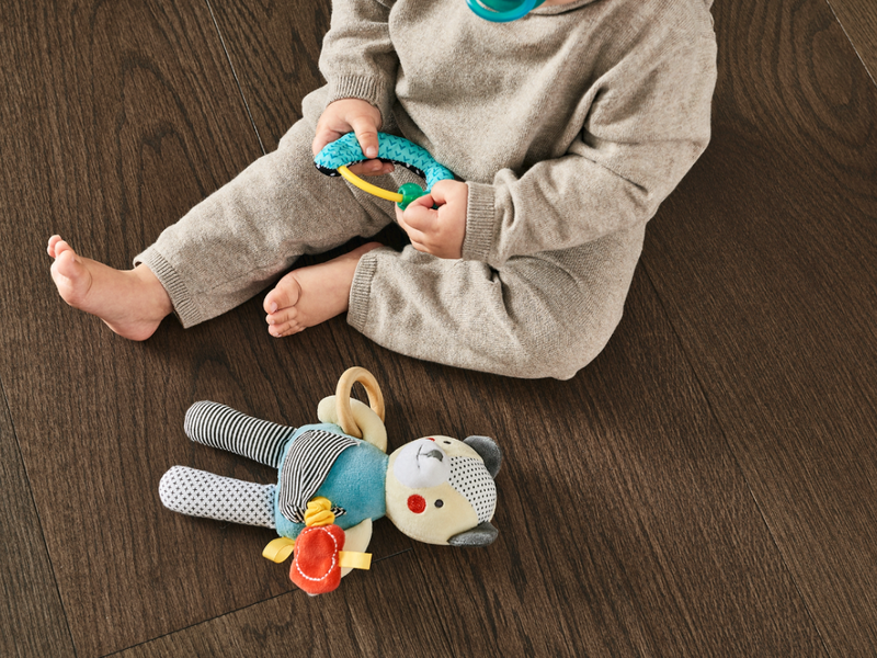 Baby playing on a clean vinyl sheet floor
